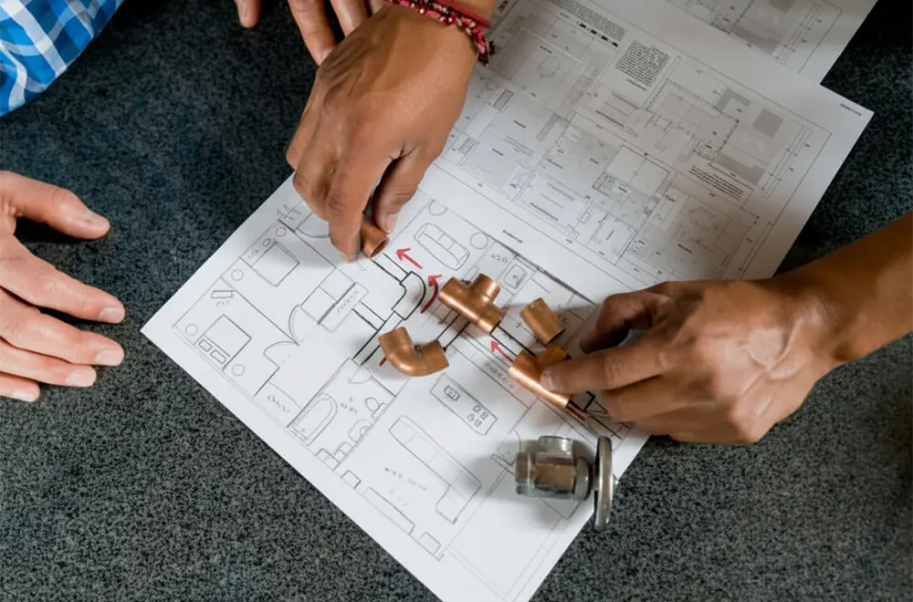 2 people reviewing fire sprinkler plans